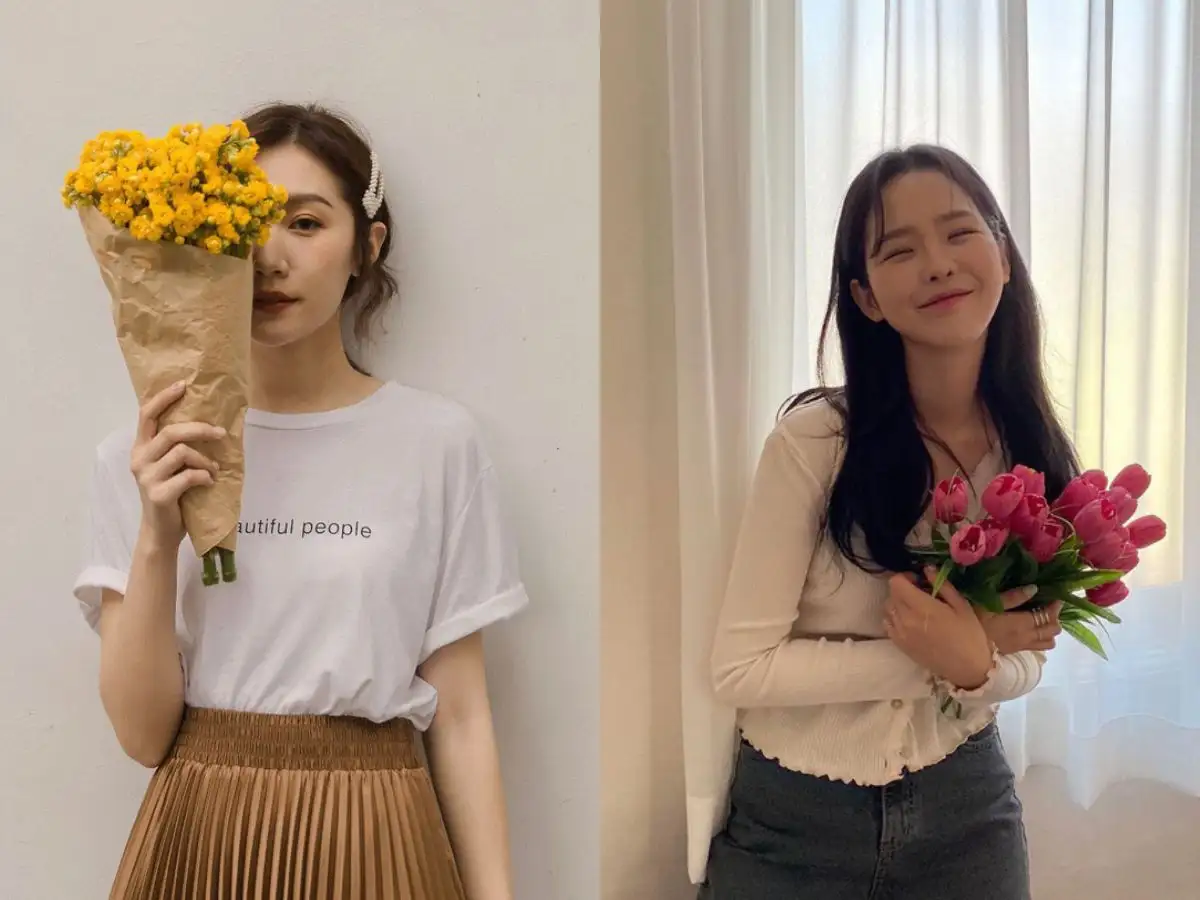 Dáng đứng dựa tường kết hợp phụ kiện hoa tạo sự mềm mại, thơ mộng
