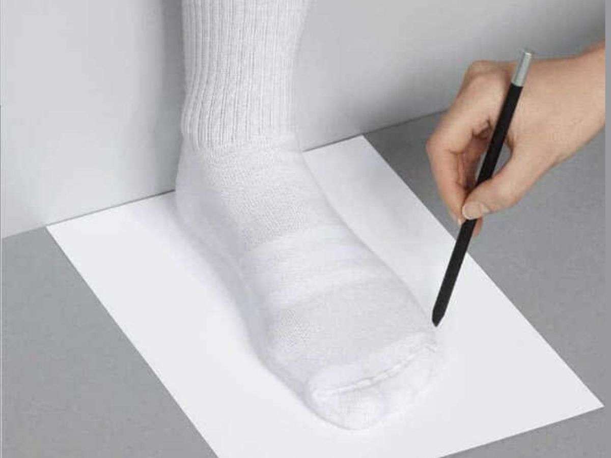 Đặt một tờ giấy trắng xuống sàn, đặt gót chân chạm vào tường