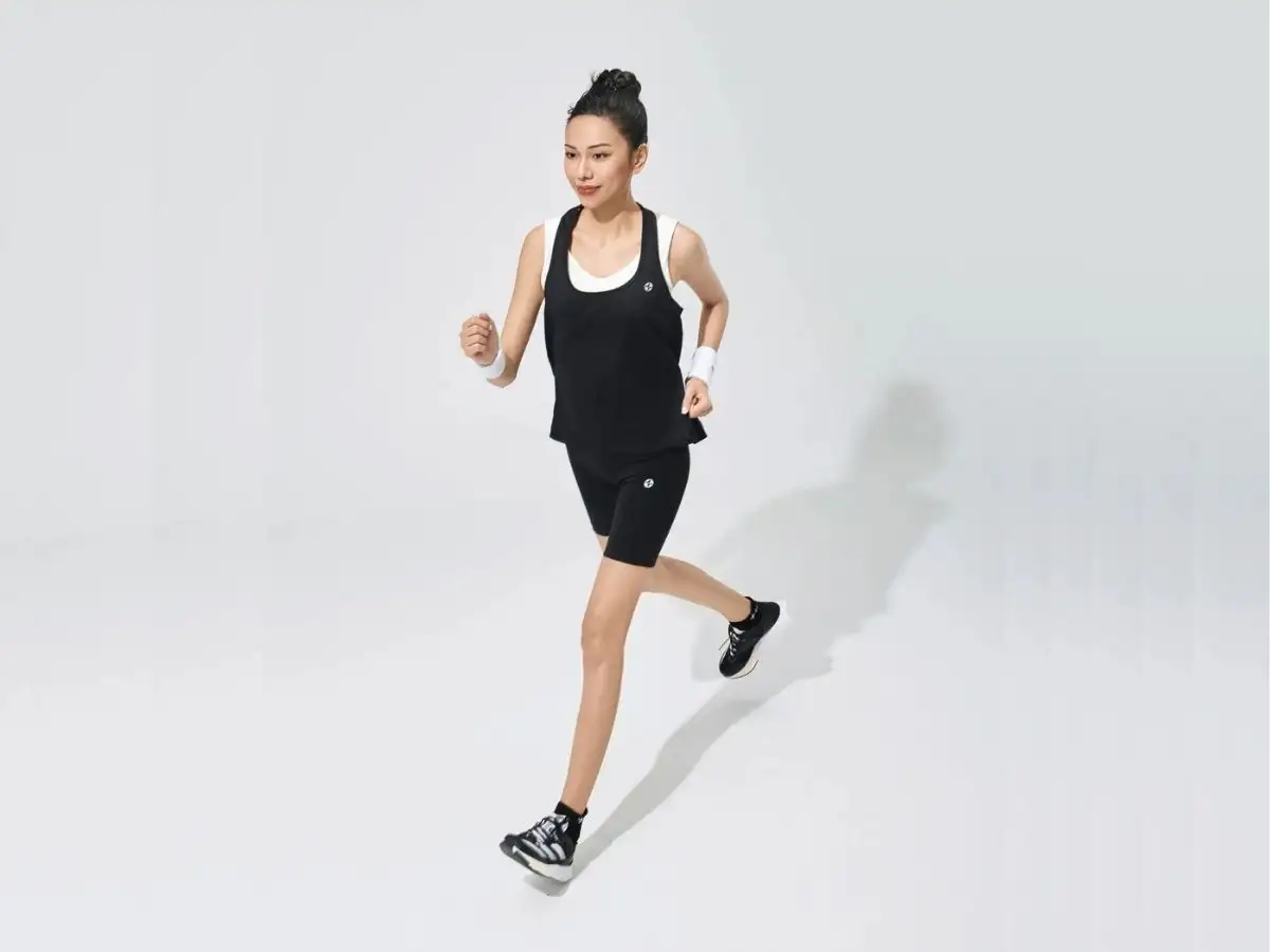 Áo singlet nữ Coolmate màu đen, kết hợp với quần short và giày thể thao