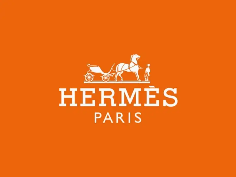 Logo Hermes: cỗ xe ngựa và quý ông lịch lãm trên nền cam