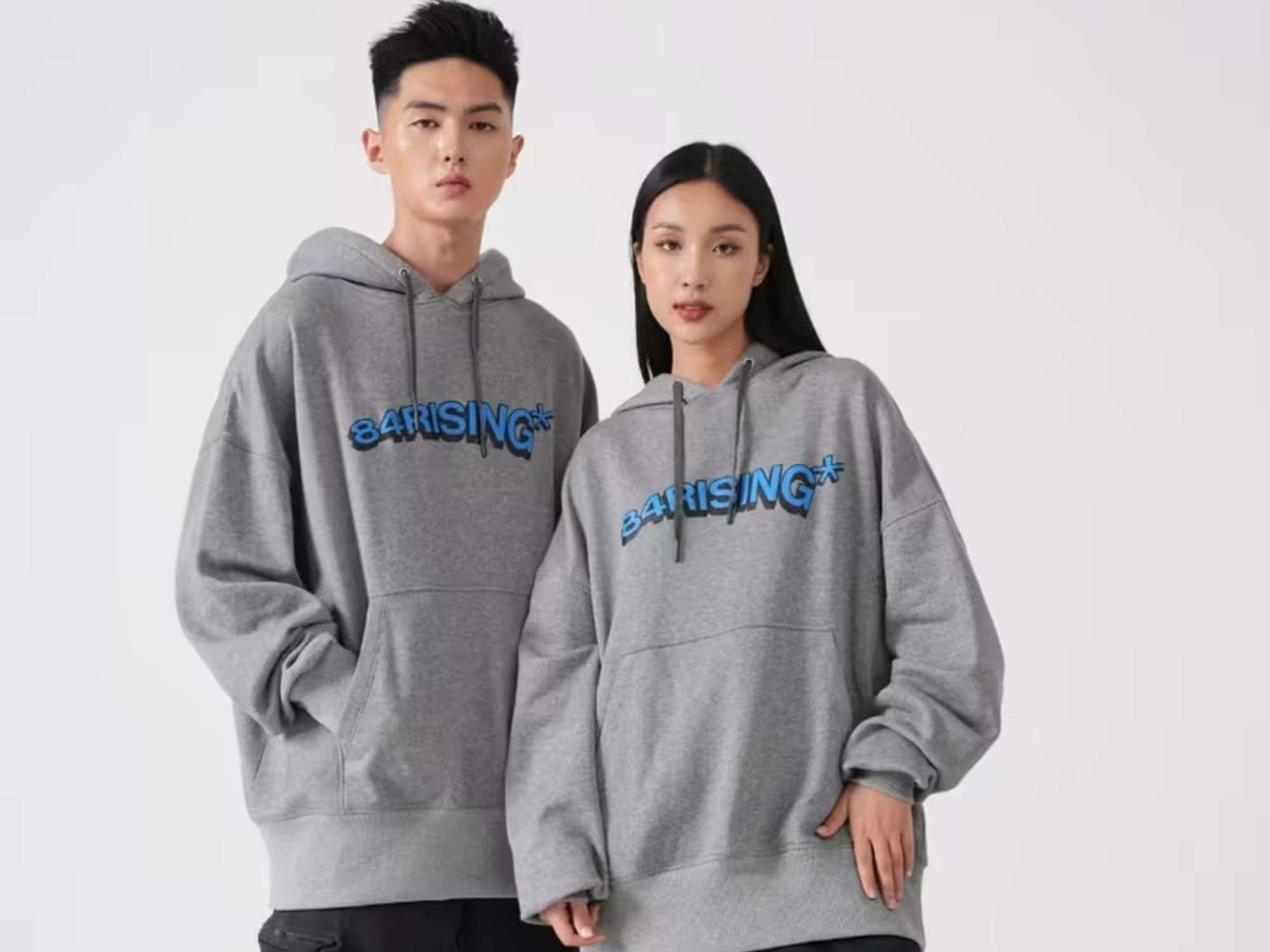 Cặp đôi nam nữ mặc áo hoodie đôi 84RISING màu xám form rộng unisex phong cách hiện đại